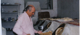 Baker taking Babylonian flat bread out of oven – Daniel Khazzoom